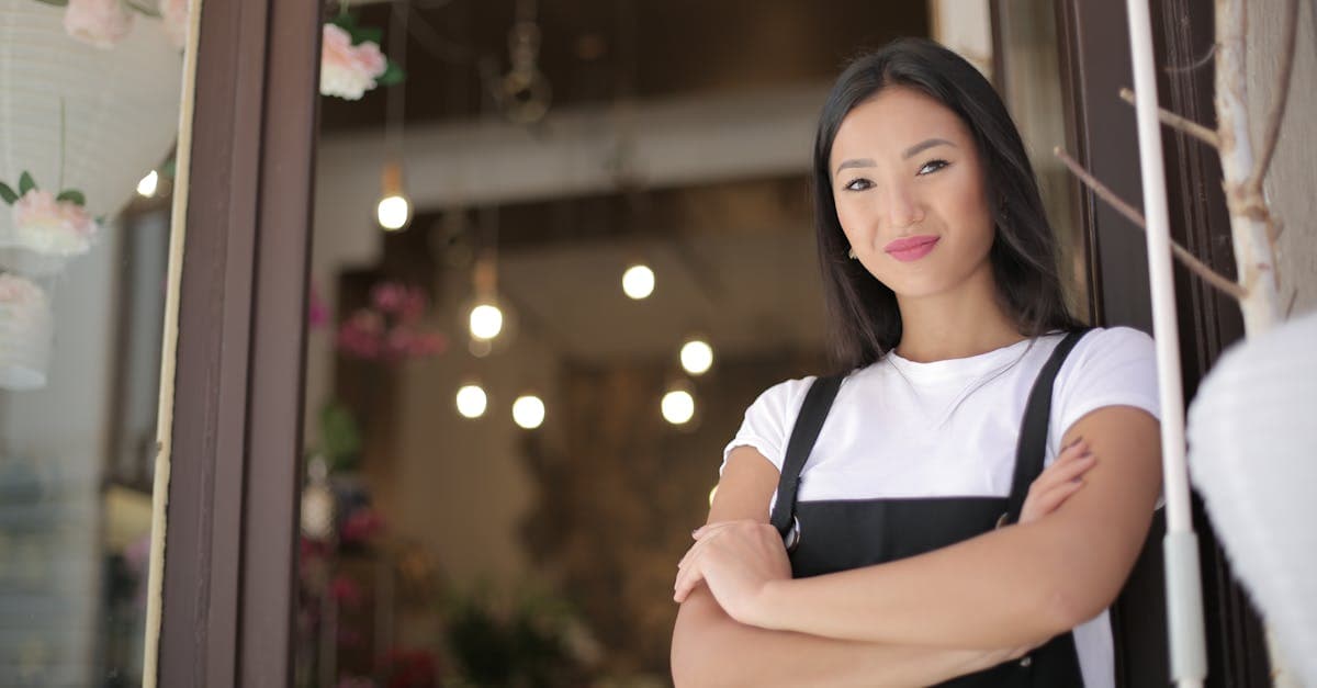 Freelancer calculating pricing on a notepad with a laptop nearby