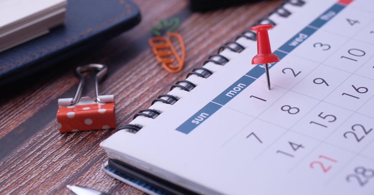 Accountant at a desk with a laptop showing a timesheet and financial reports