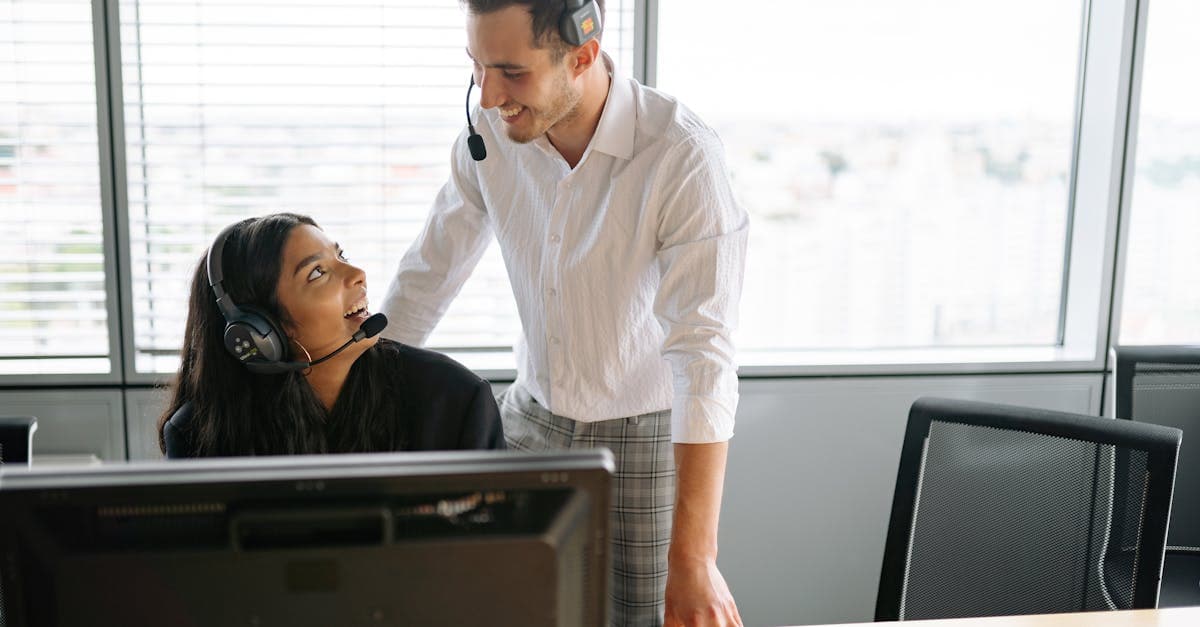 Two support agents communicating during a warm call transfer with customer on hold