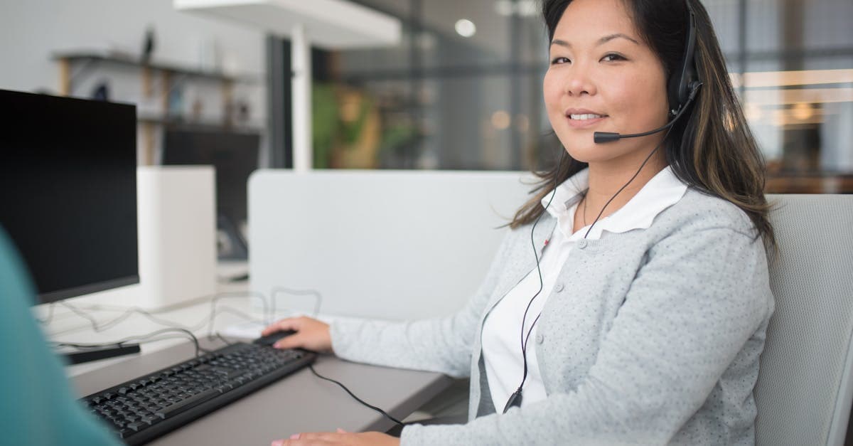 Support agent working at a helpdesk dashboard on a laptop